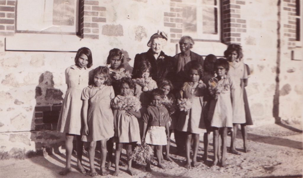 Mrs Rutter with Prince Rudy Dinah and a group of Carrolup girls. The girl second from the left is Mildred Jones. Photographer: Noel White, 31st July 1949. Noel & Lily White Collection.