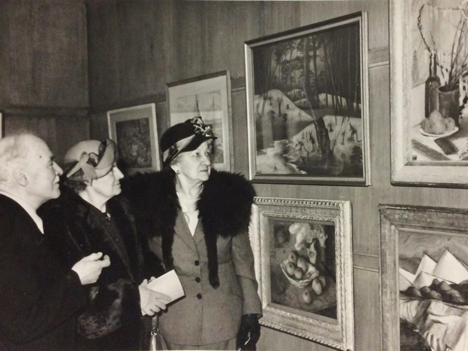 Parnell Dempster's Down to Drink adorns a wall at the 45th Annual Exhibition of the Pastel Society in London, 1951. Mrs Rutter proudly discusses the drawing with Mr and Mrs Richter. Mary Durack Miller Collection, J. S. Battye Library of West Australian History, 1951.